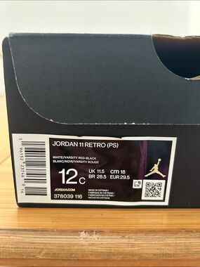 Jordan 11 Retro Kids Sneakers in White, Varsity Red, Black.